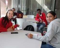 currents students around table with 博彩网站 supplies