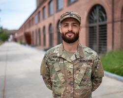 veteran in army uniform with arms behind back